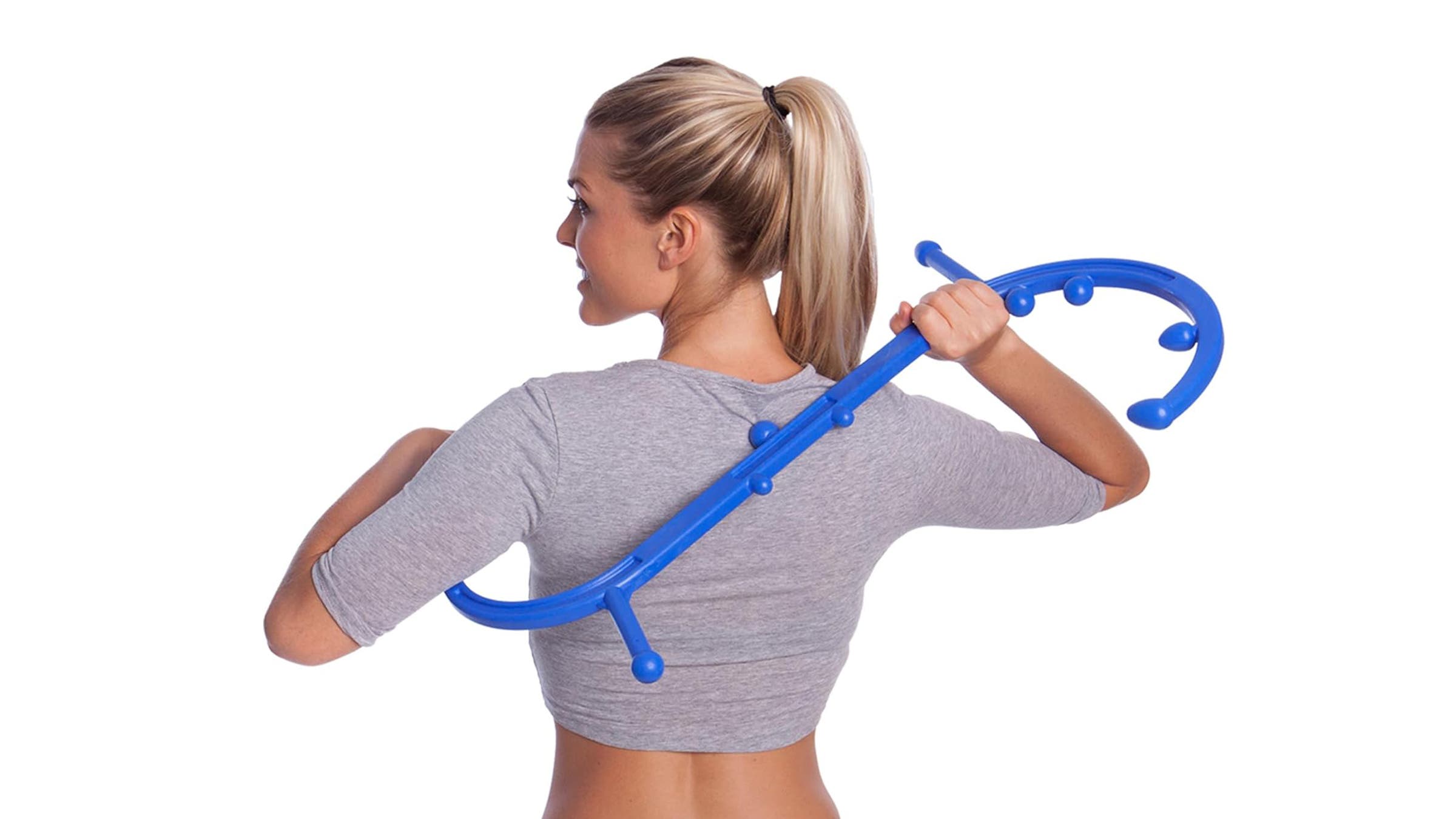Body Back Buddy self-massage tool being used by a woman