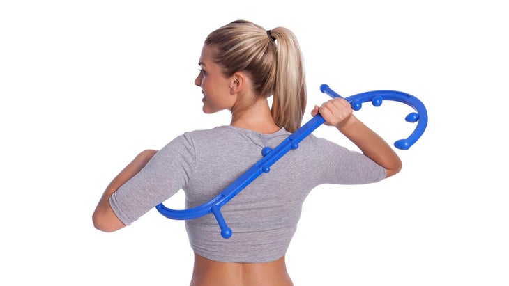 Body Back Buddy self-massage tool being used by a woman