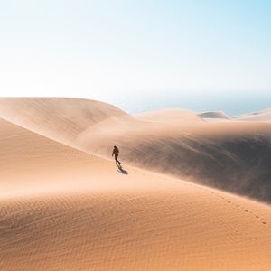 man walks alone in desert