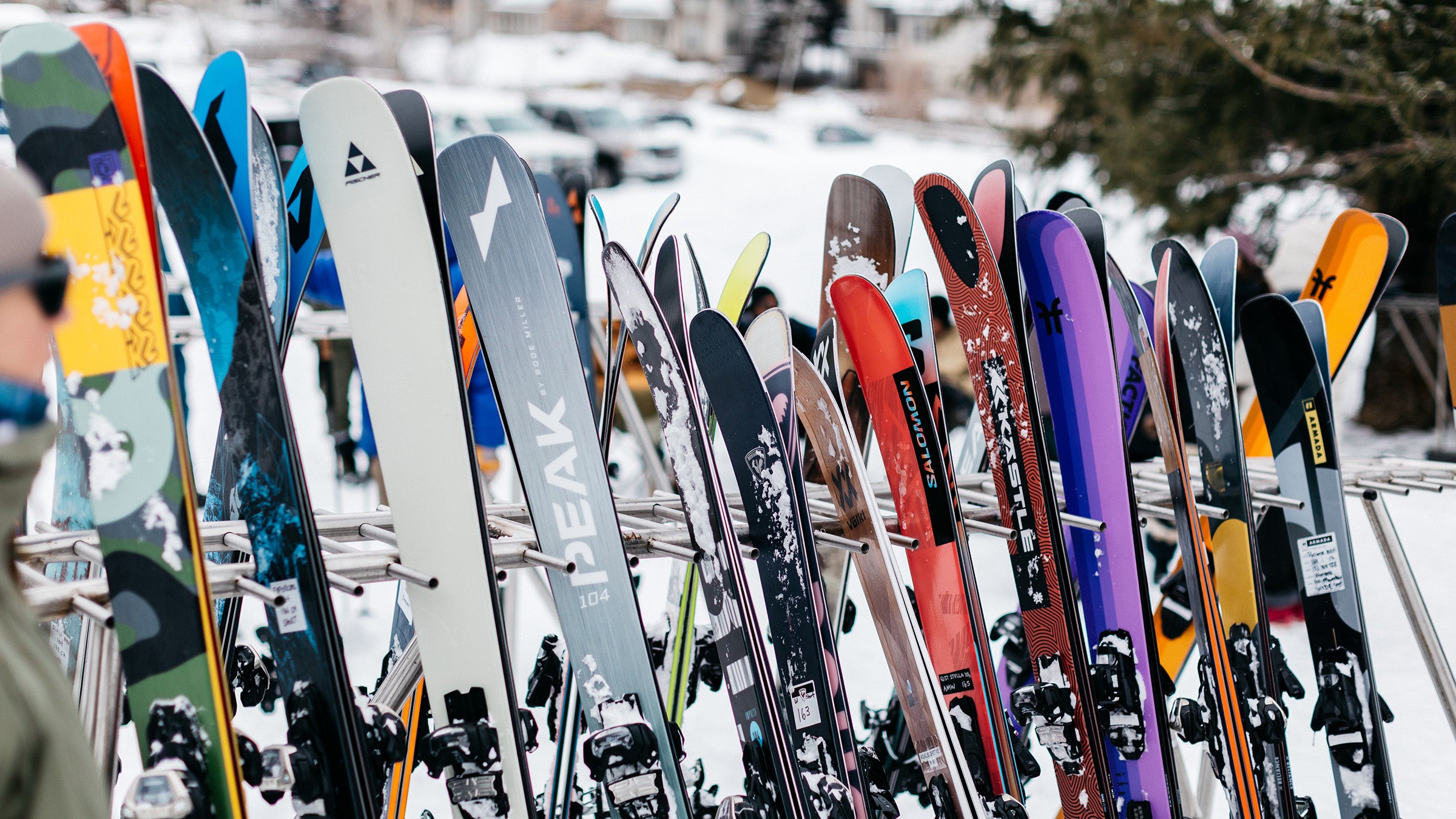All-mountain skis on ski rack at ski resort base area