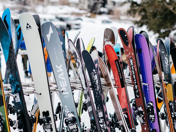 All-mountain skis on ski rack at ski resort base area