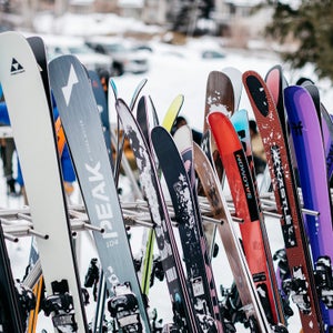 All-mountain skis on ski rack at ski resort base area