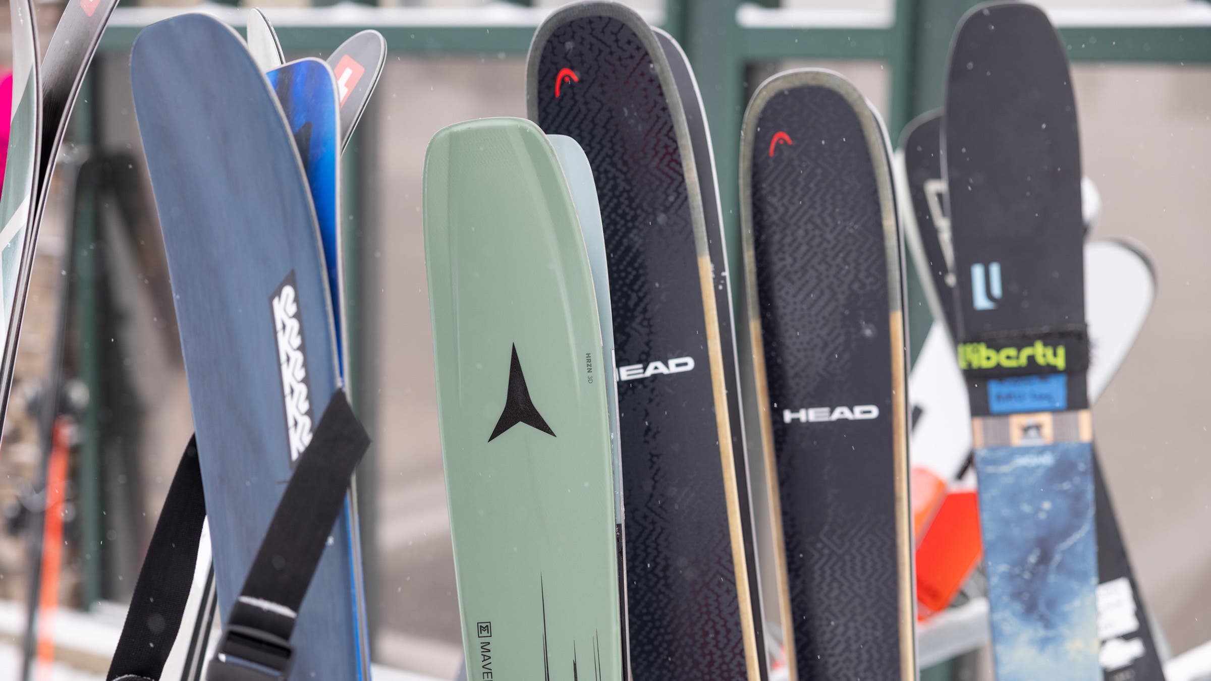 Closeup of 2025 all-mountain skis displayed on ski rack at base of SKI Test