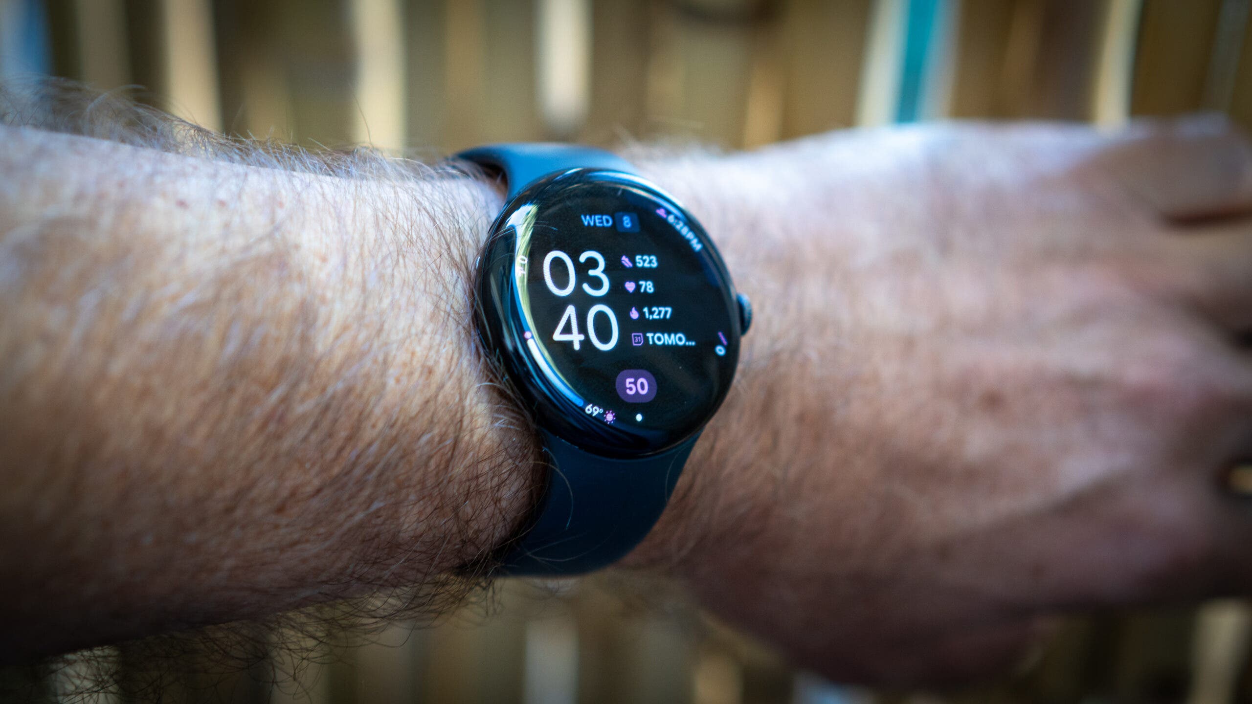 black Google Pixel 4 smartwatch on man's wrist displaying the time