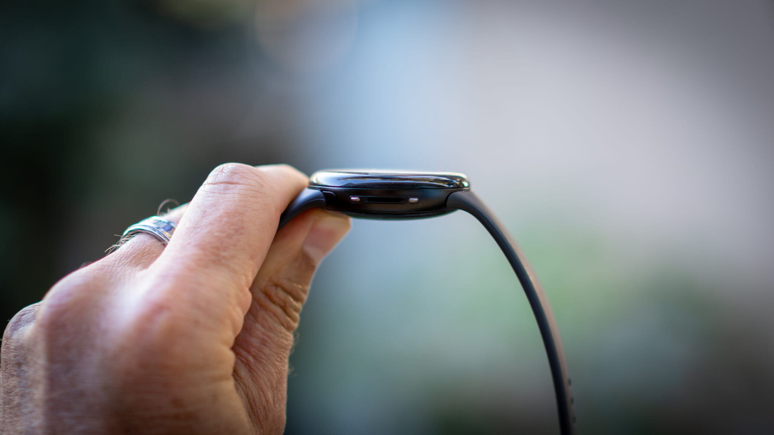 man's hand holds up side profile of Google Pixel 4 Watch