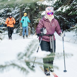 Snowy forest backcountry ski midlayer testing