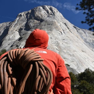 A climber stands near El Capitan with his climbing equipment at Yosemite National Park