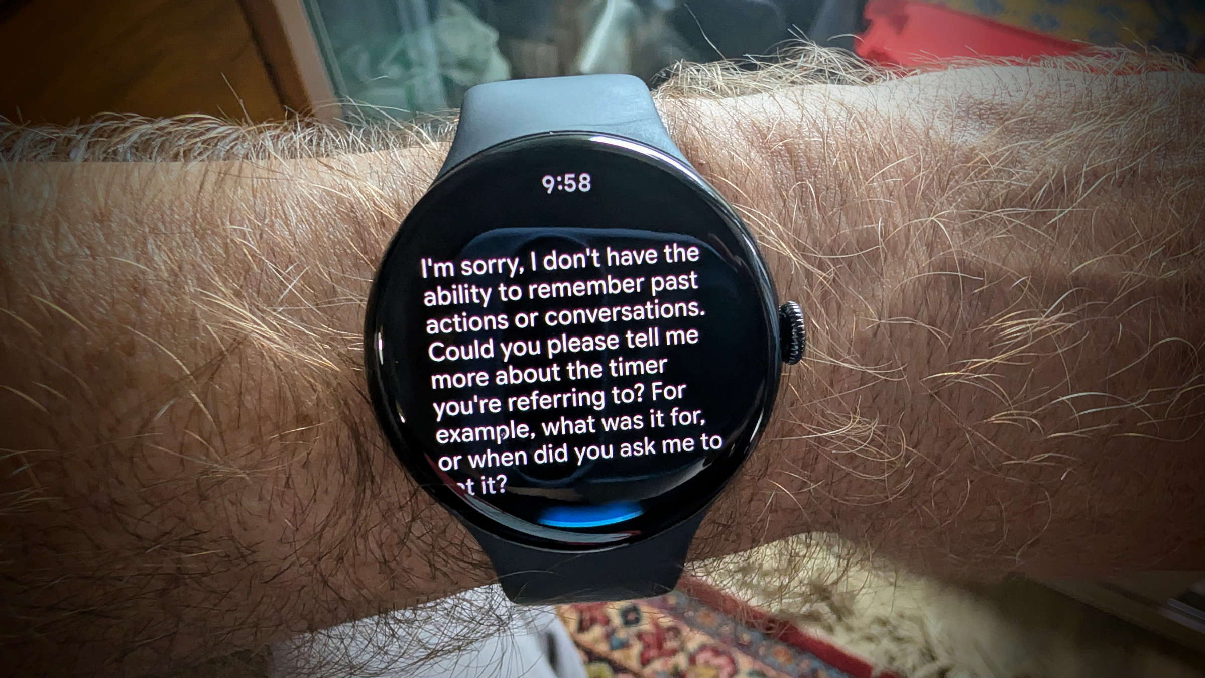 Black Google Pixel 4 watch on man's wrist displaying message from AI that stars with "I'm sorry ..."
