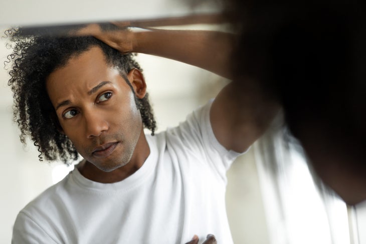 Man assesing hair