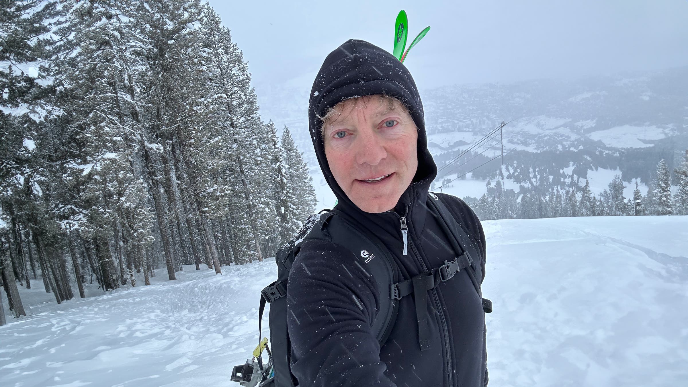 Houdini Power Hoodie black on ski hill snowing