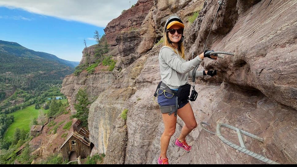Jen Murhpy perched on a via ferrata.