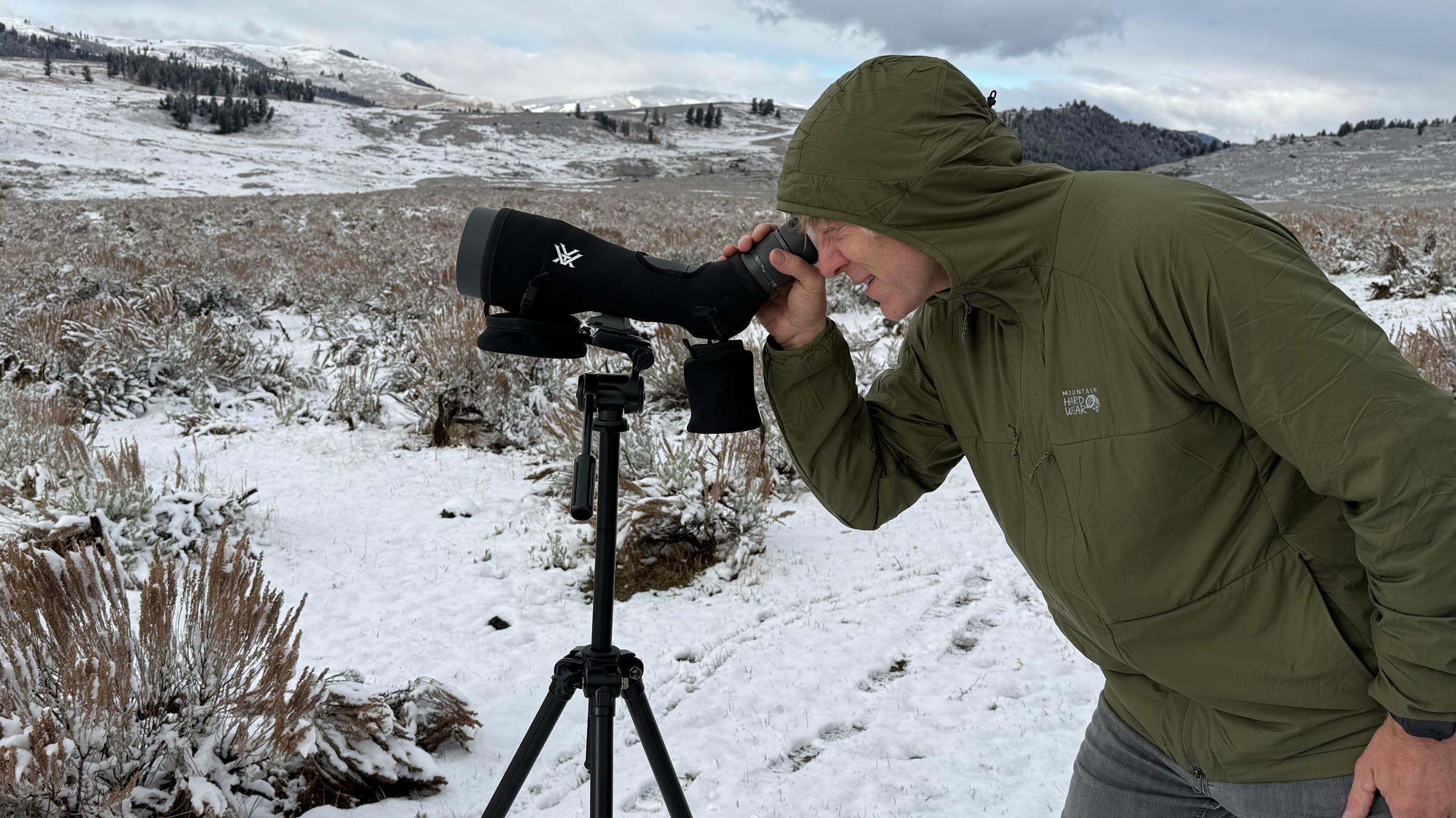 Mountain Hardwear KorAirshell on white background green looking through scope