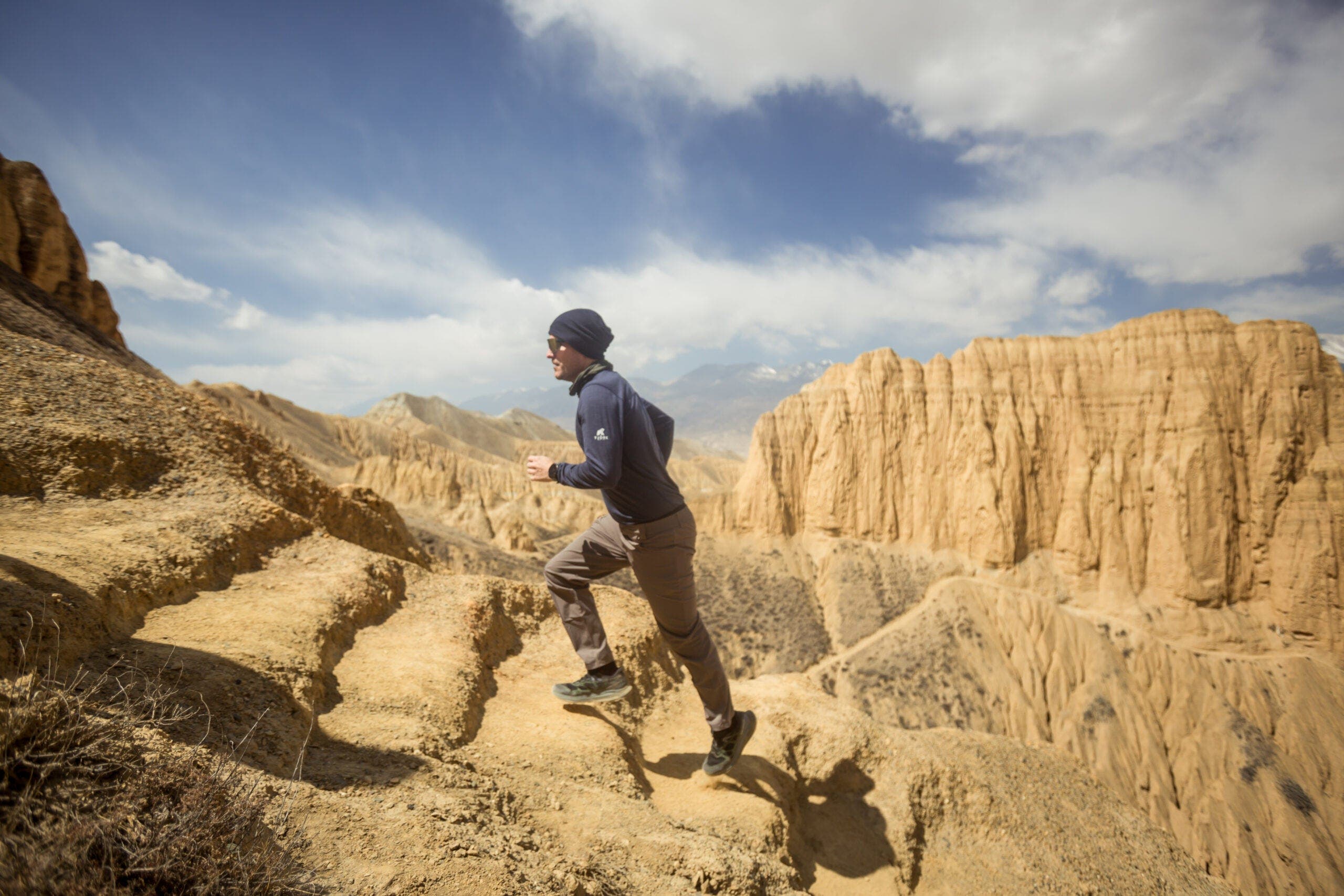 a man sprints up steps Upper Mustang Trek
