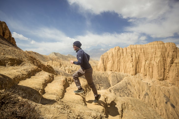 a man sprints up steps Upper Mustang Trek