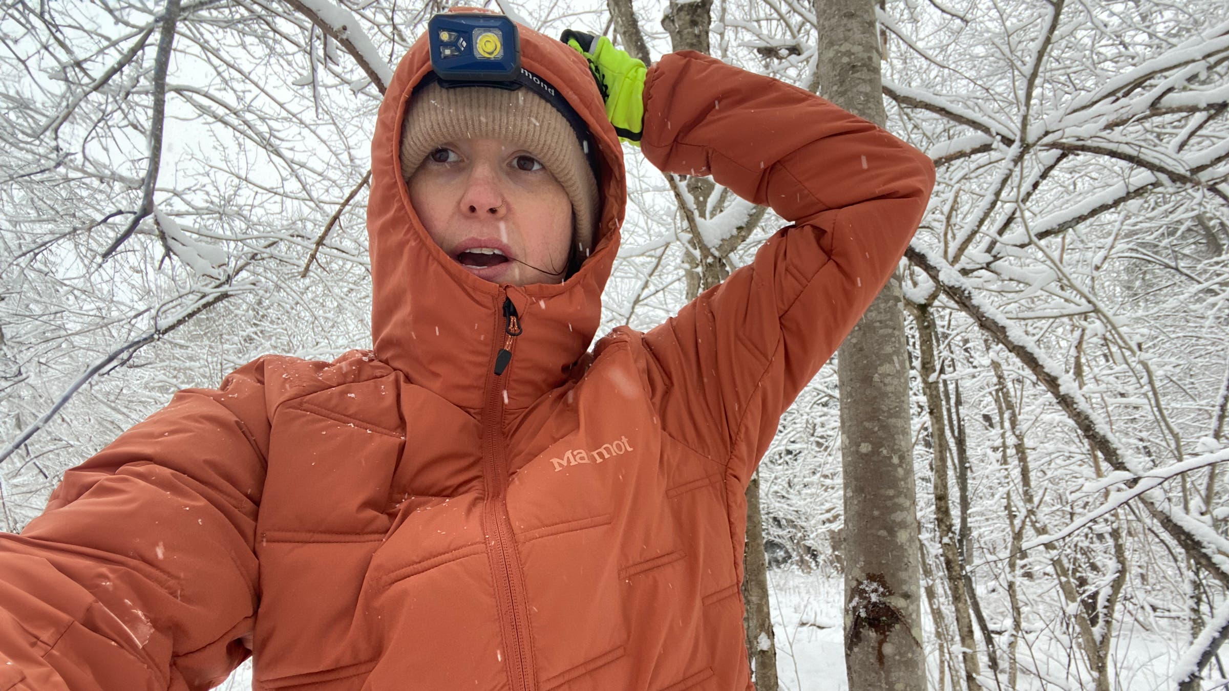 Marmot WarmCube Active Novus Hoody orange in snowy forest midlayer