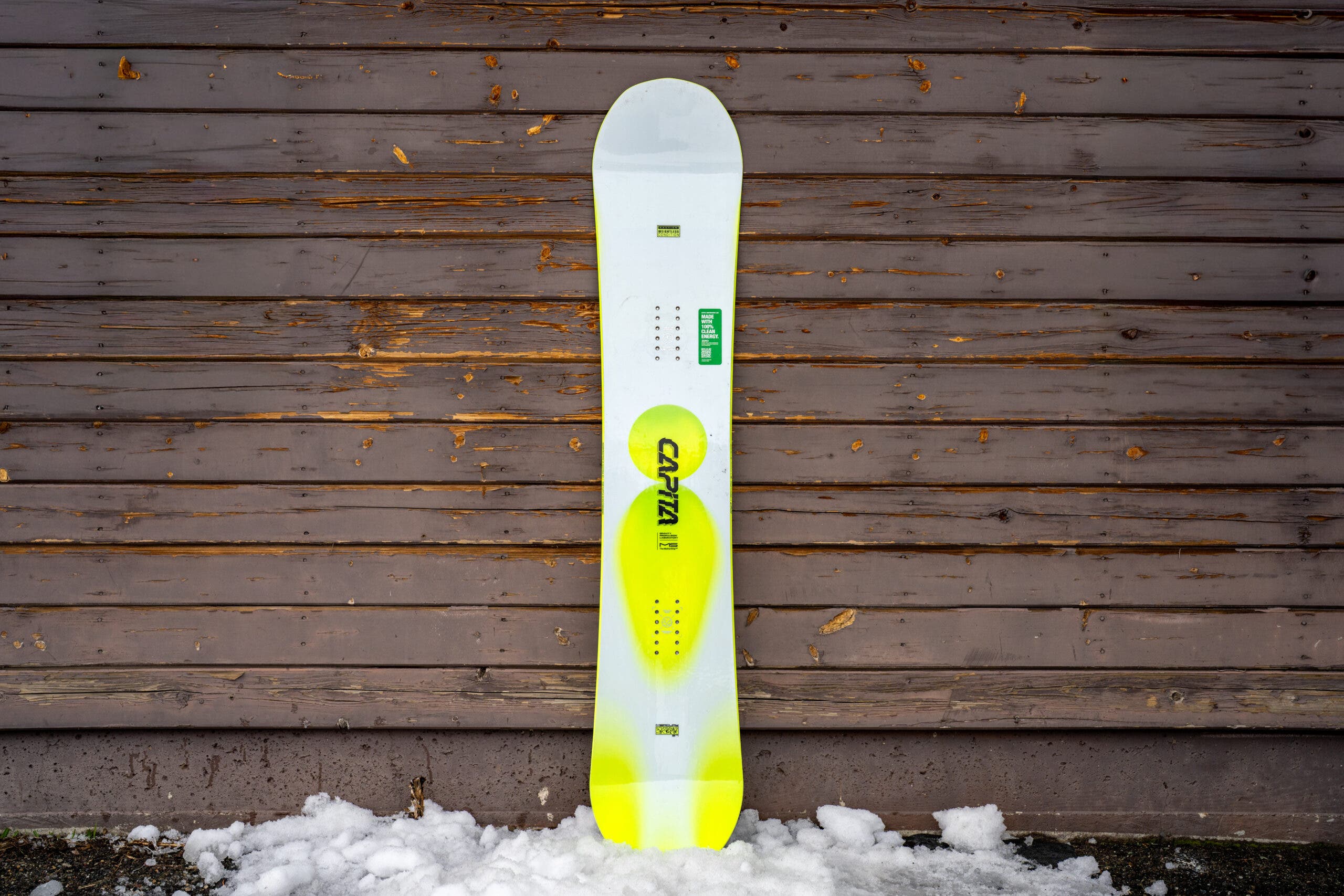 capita mercury snowboard leaning against weathered building