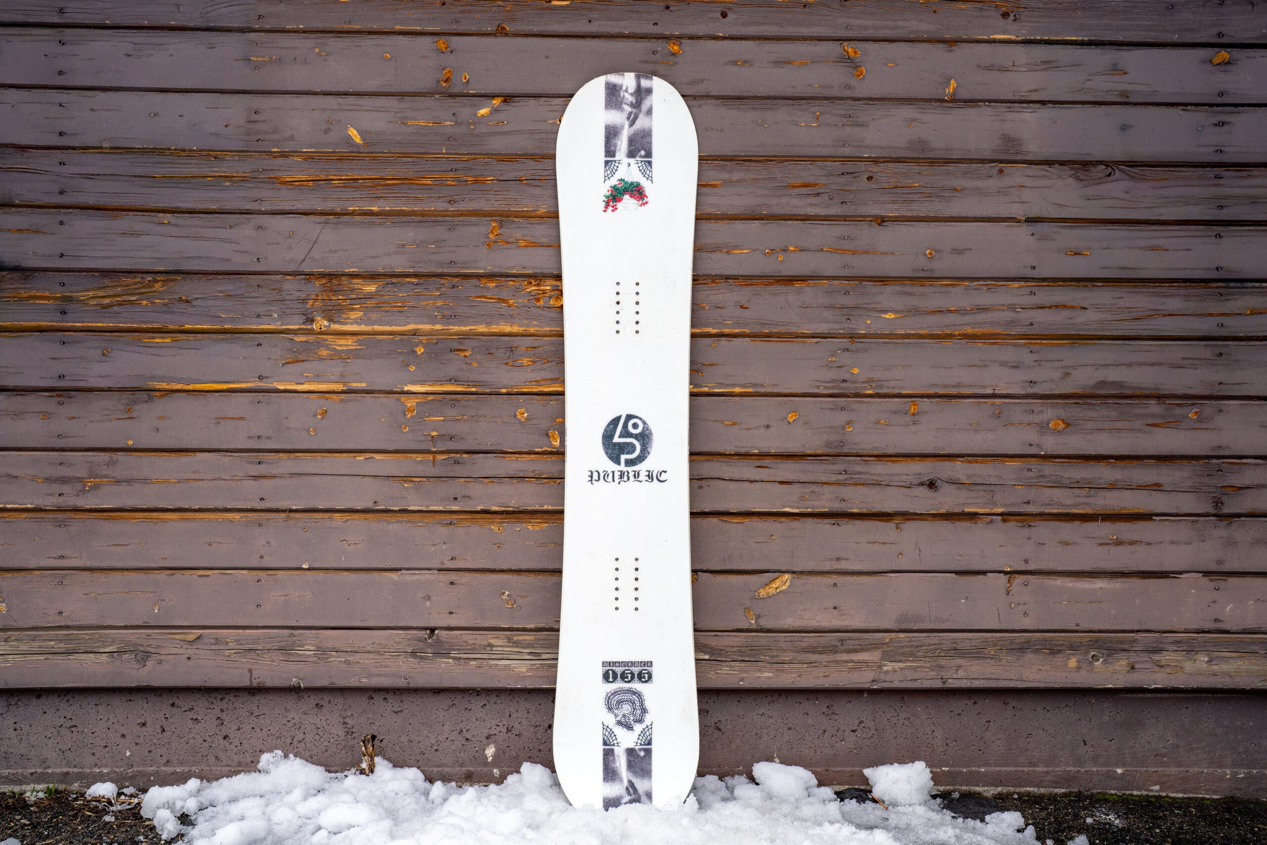 public disorder snowboard leaning against weathered building