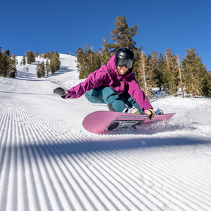 woman riding snowboard on corduroy