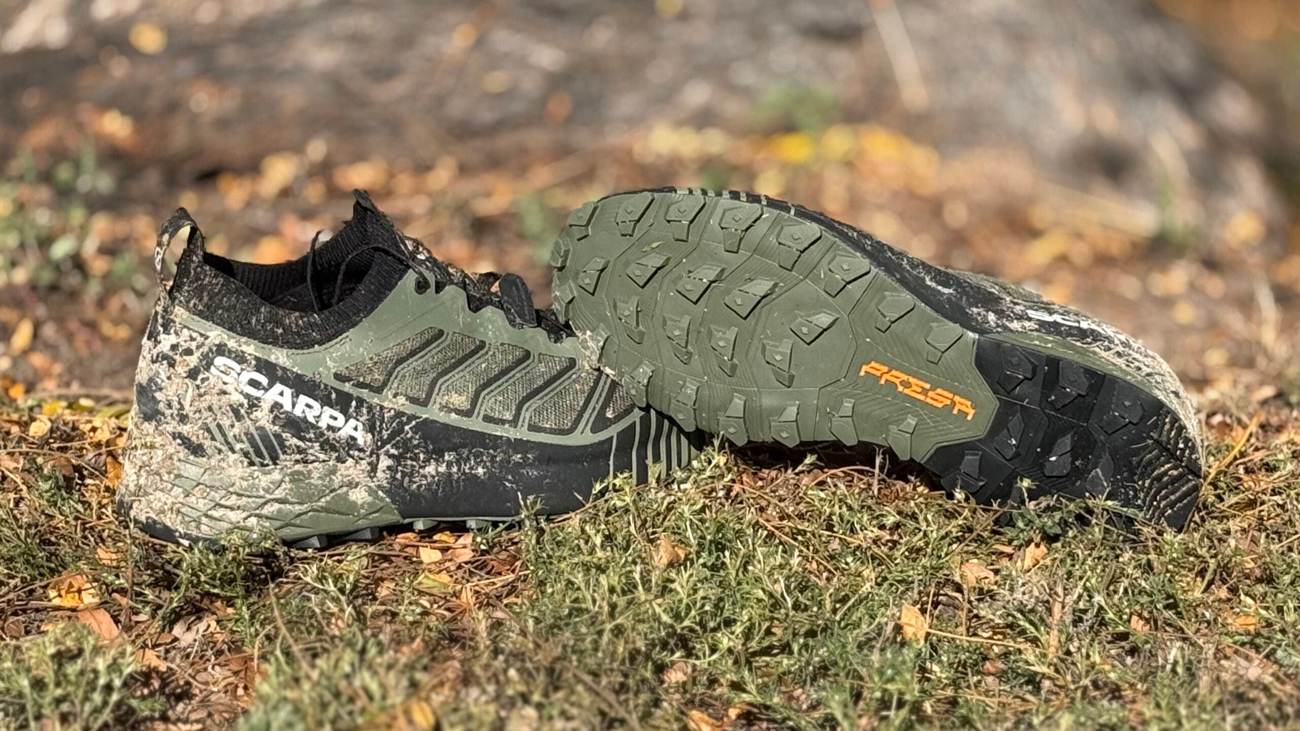 2025 Scarpa Ribelle Run 2 trail running shoes tested on the trail, shown with dried mud on the black and green shoe