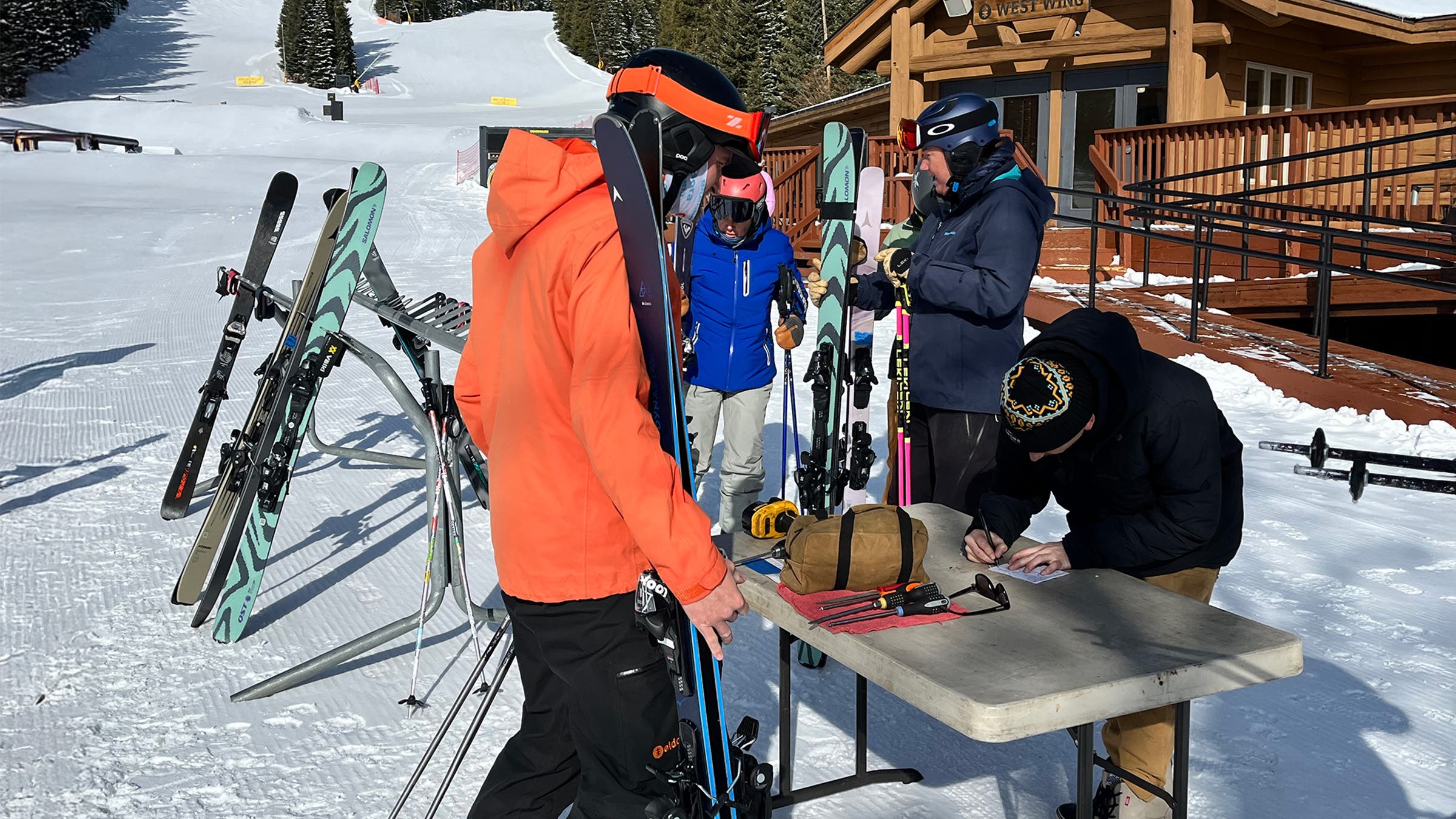 Skiers standing at table at base of Eldora Mountain during SKI/Outside intermediate ski test