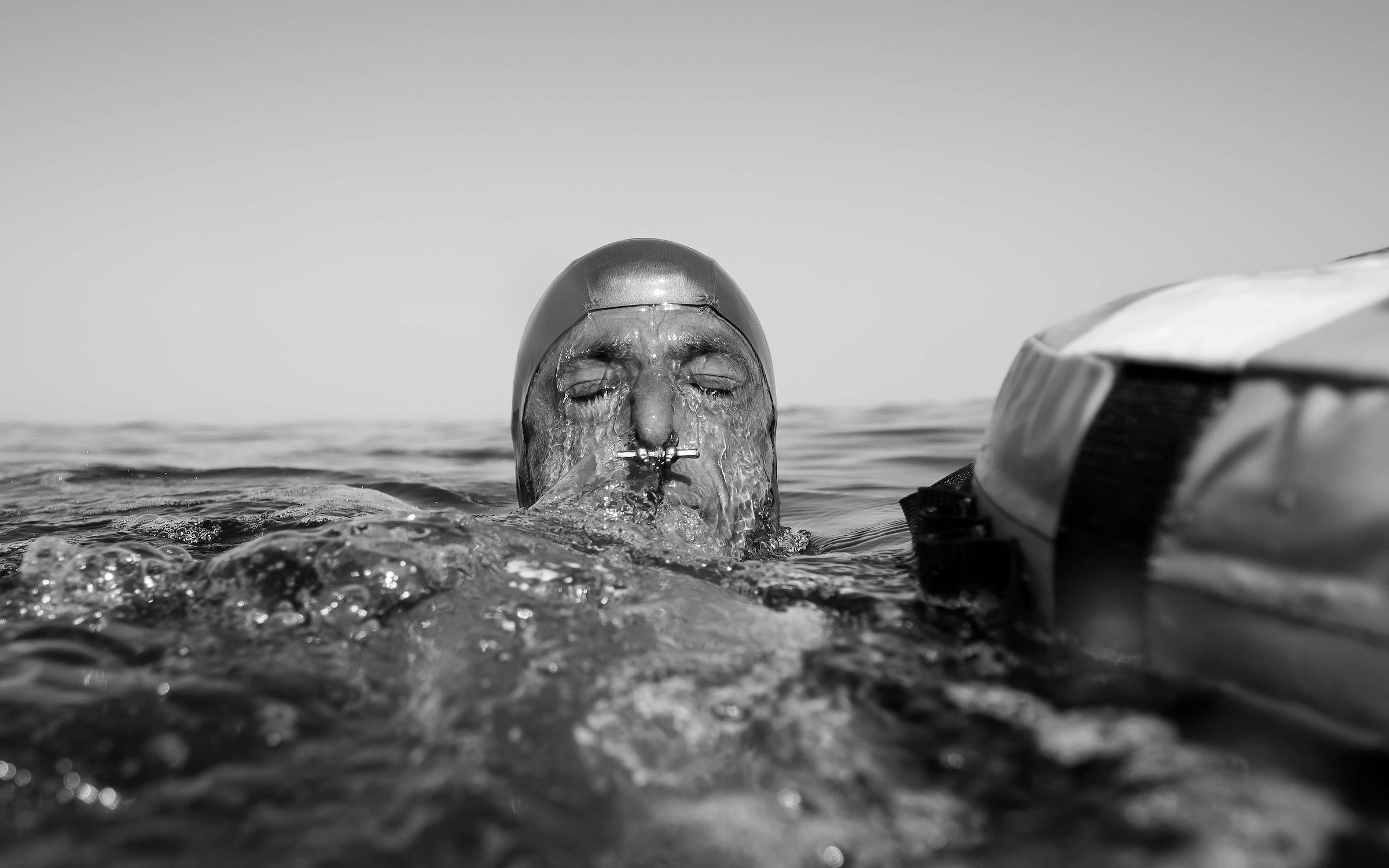 Šobat surfacing with a nose clip visible after a dive in Blue Hole, Dahab, in 2020. Freedivers use nose clips to maintain air pressure in the nasal passage and prevent water from entering the nose.
