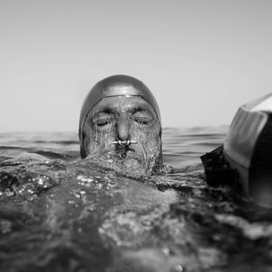 Šobat surfacing with a nose clip visible after a dive in Blue Hole, Dahab, in 2020. Freedivers use nose clips to maintain air pressure in the nasal passage and prevent water from entering the nose.