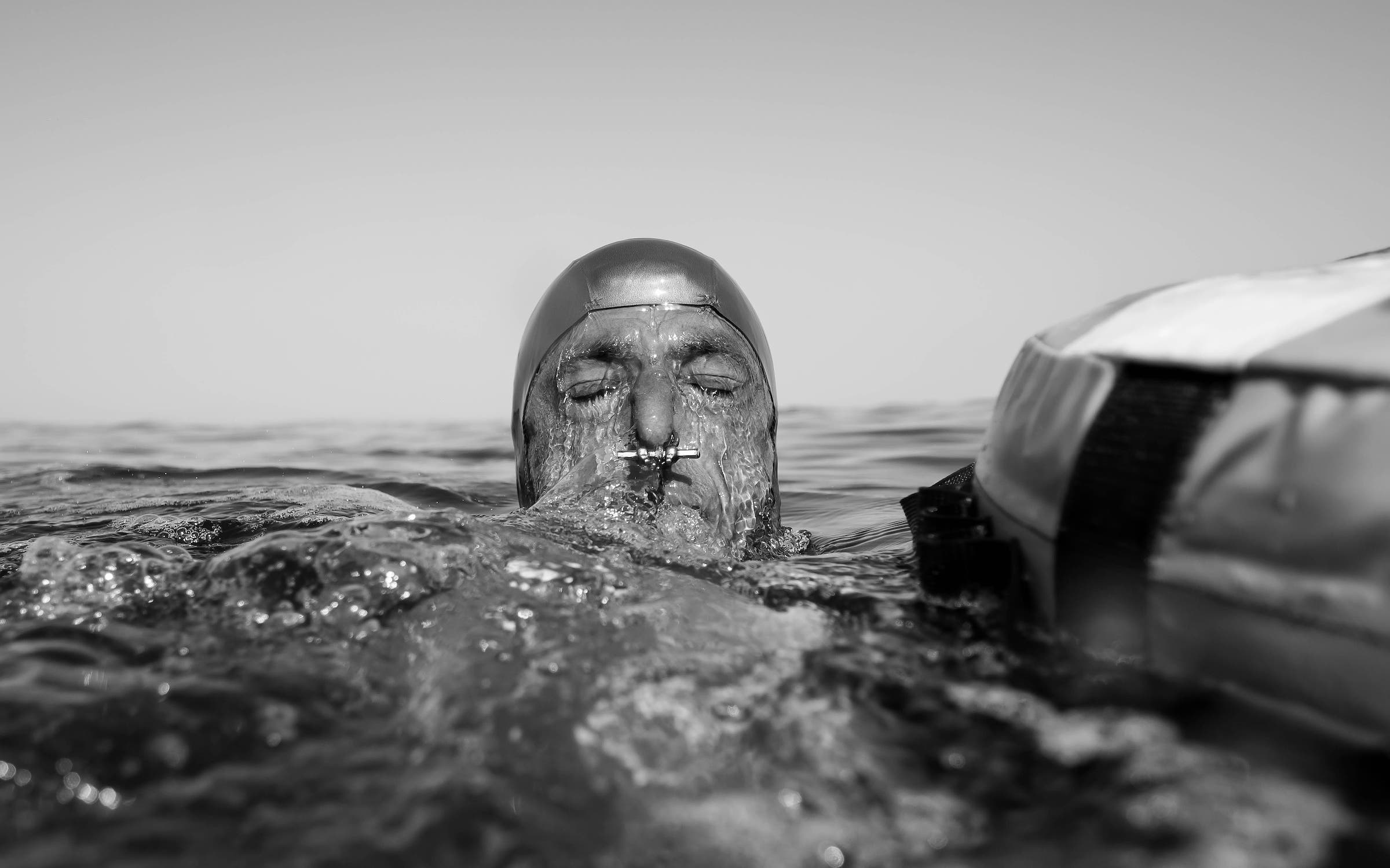 Šobat surfacing with a nose clip visible after a dive in Blue Hole, Dahab, in 2020. Freedivers use nose clips to maintain air pressure in the nasal passage and prevent water from entering the nose.