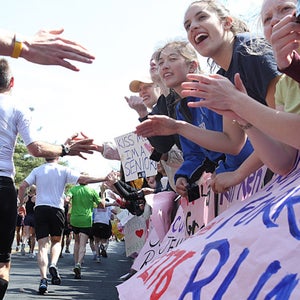 Runners make their way past cheering Wellesley College students during the 115th Boston Marathon