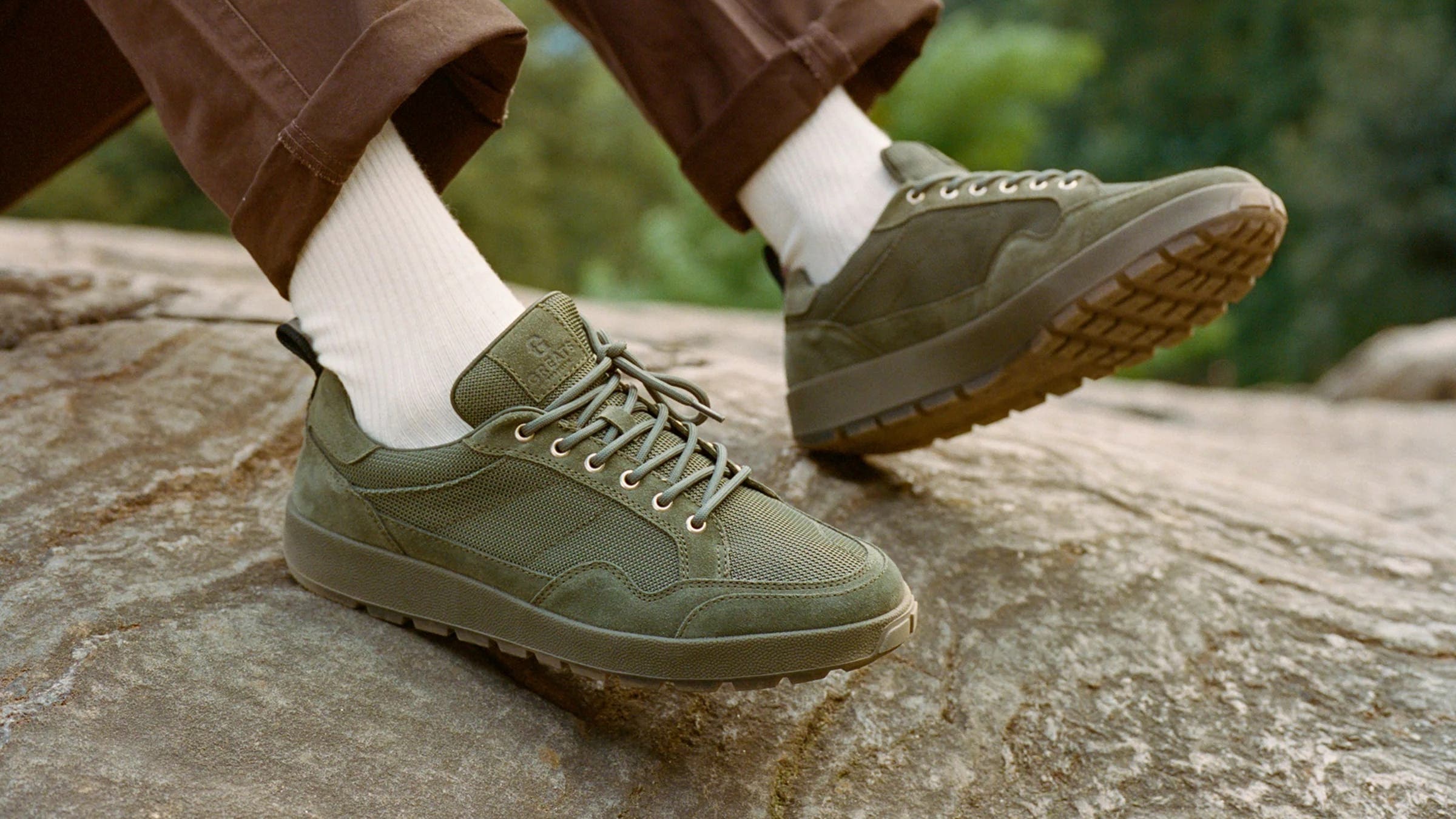 green greats ravine sneakers being worn in a park