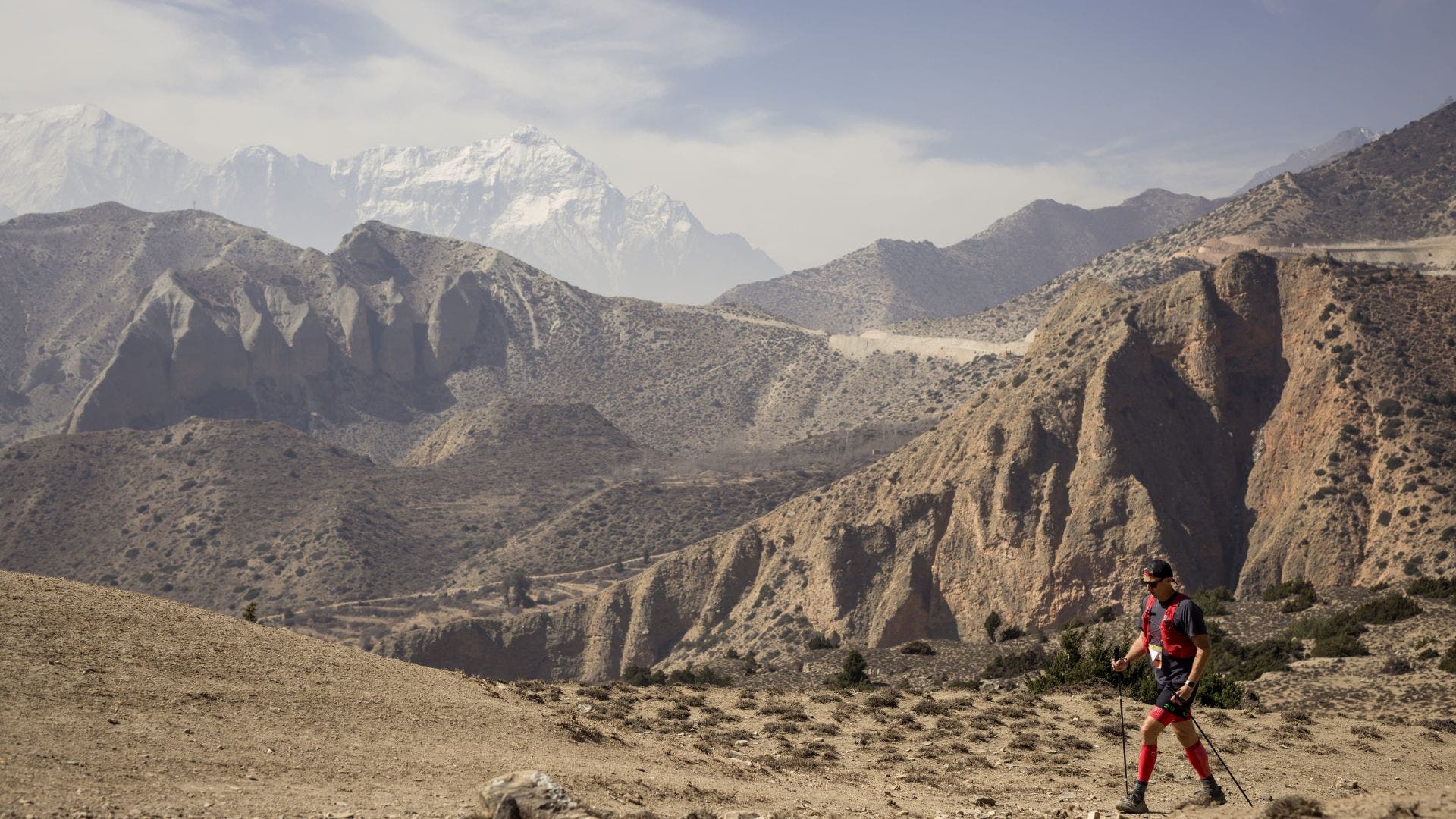 a desolate landscape with a man running through it
