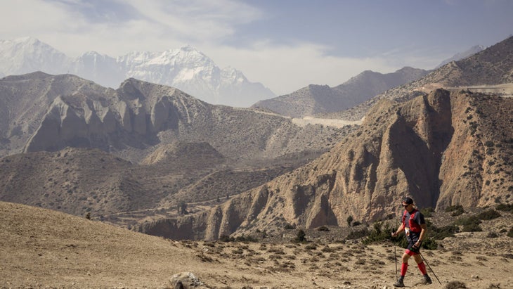 a desolate landscape with a man running through it