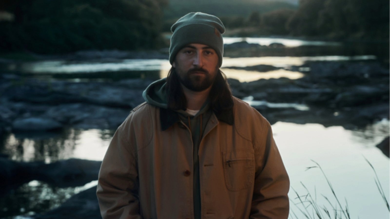 Noah Kahan wearing LL Bean by a river