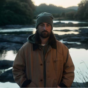 noah kahan wearing ll bean by a river