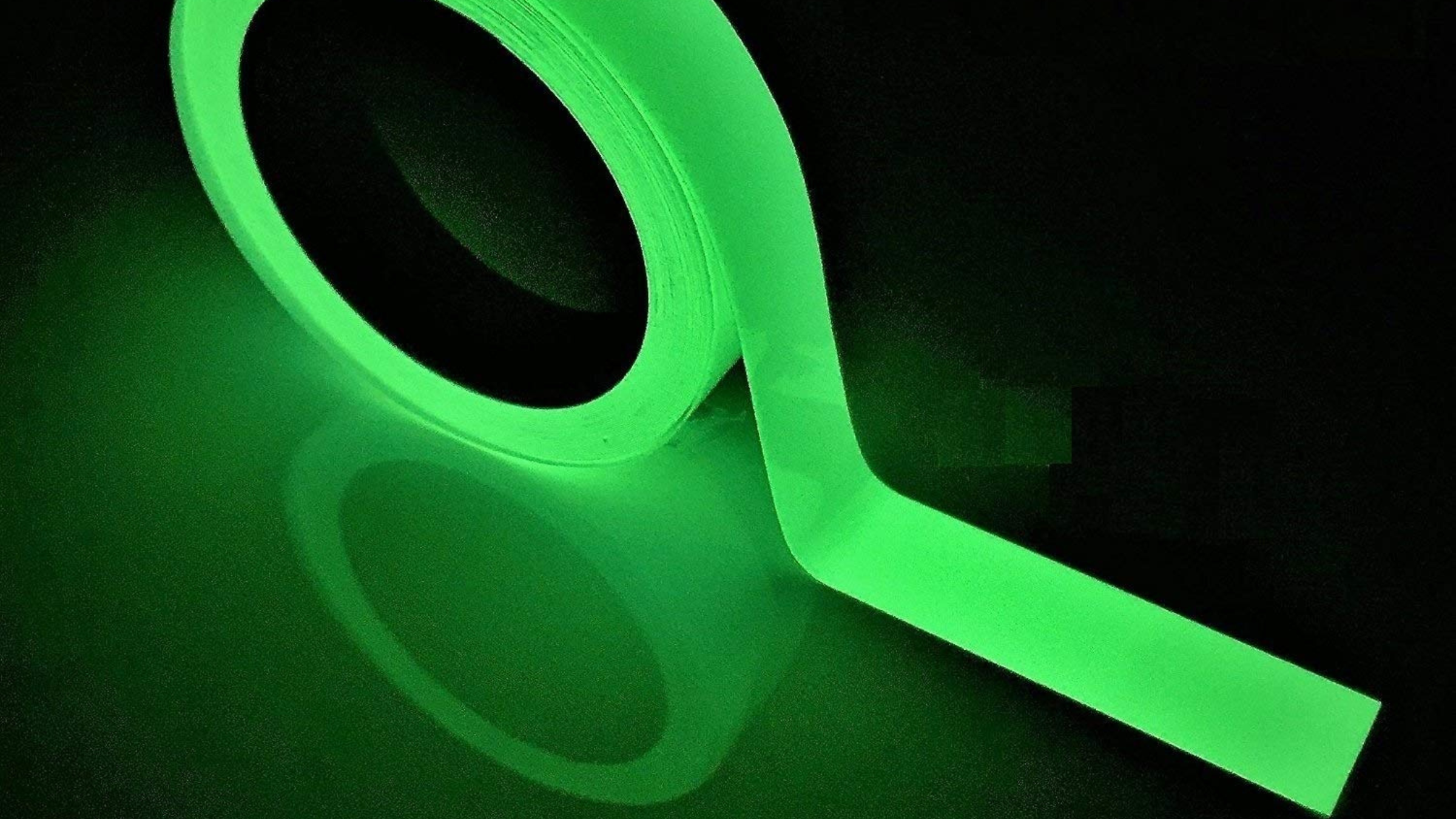glow-in-the-dark roll of tape on black reflective background, stargazing gear