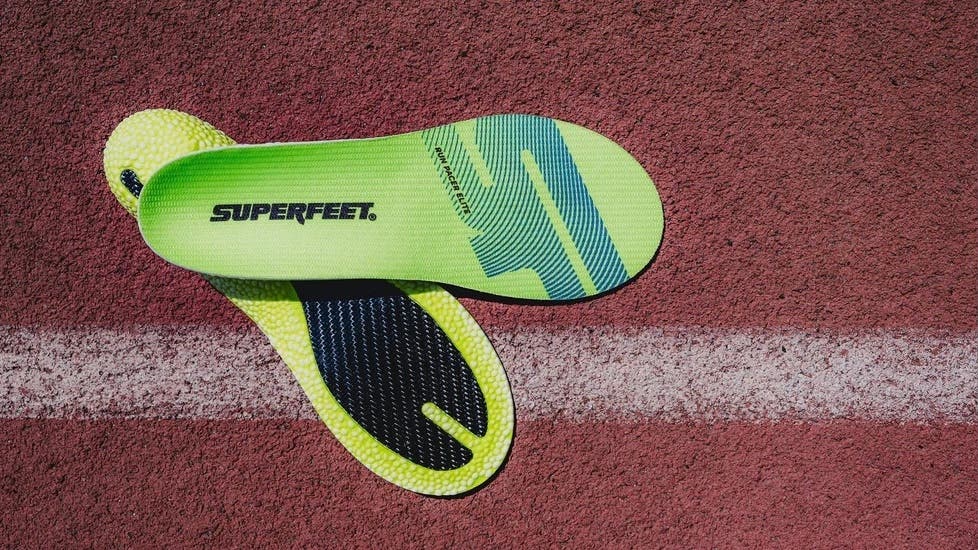green superfeet run pacer elite insoles on a red track