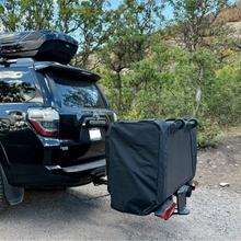 black Toyota 4Runner parked outside with Thule Outset hitch-mounted car tent set up behind it