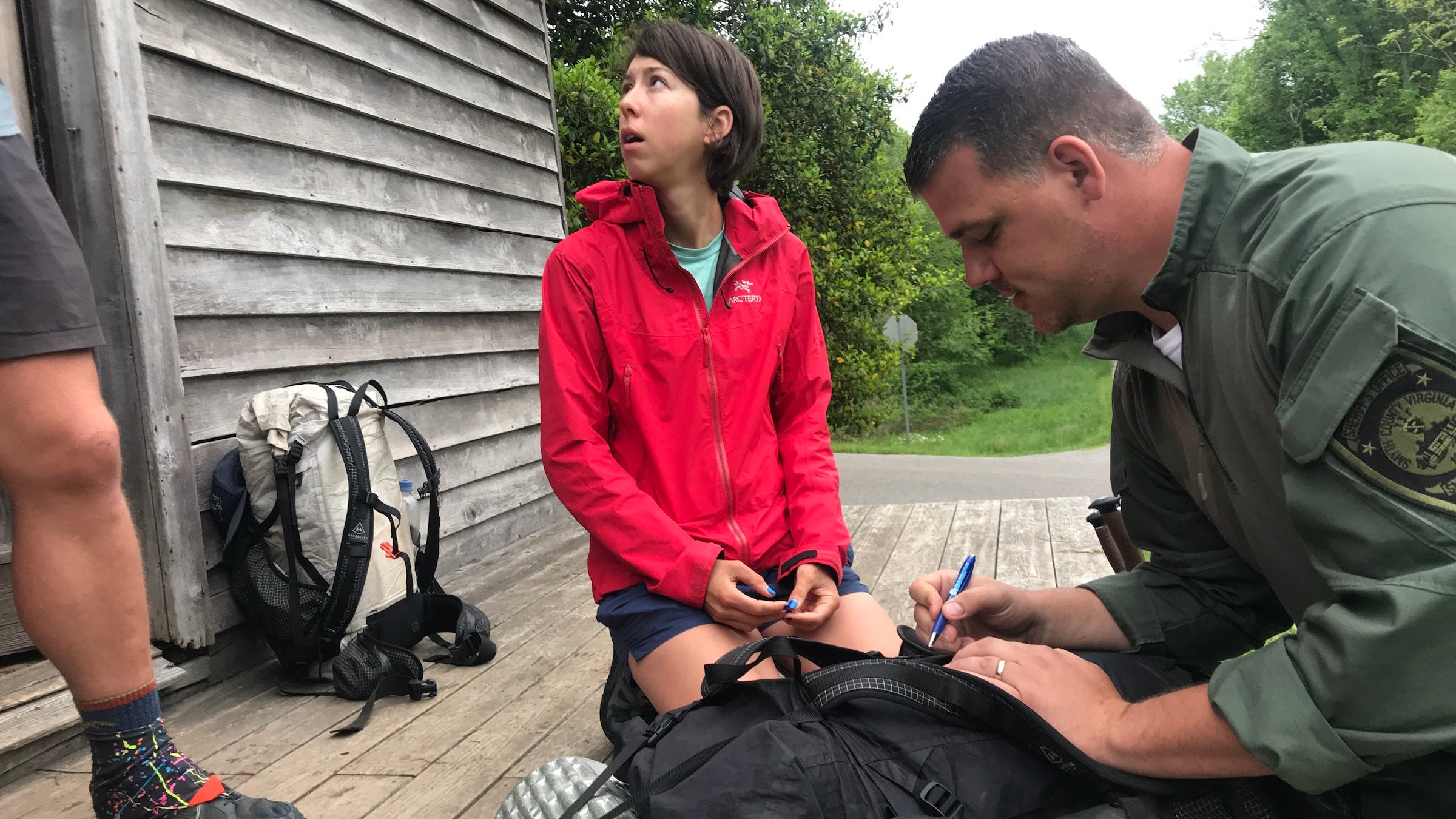 woman in red talking to police