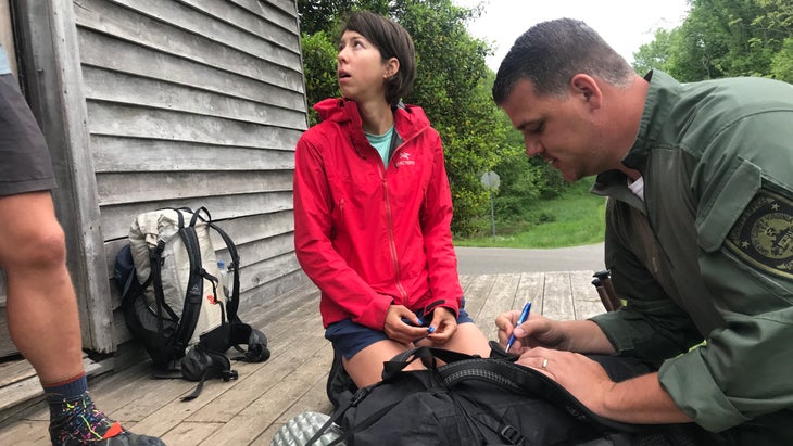 woman in red talking to police