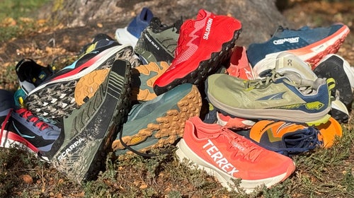 The best trail running shoes piled on dirt after testing by Outside editors