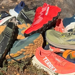 Trail running shoes in pile after testing