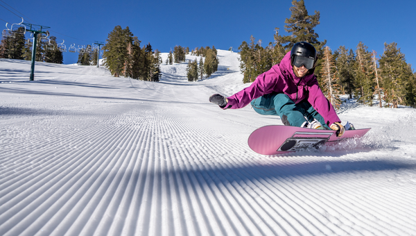 woman riding snowboard on corduroy