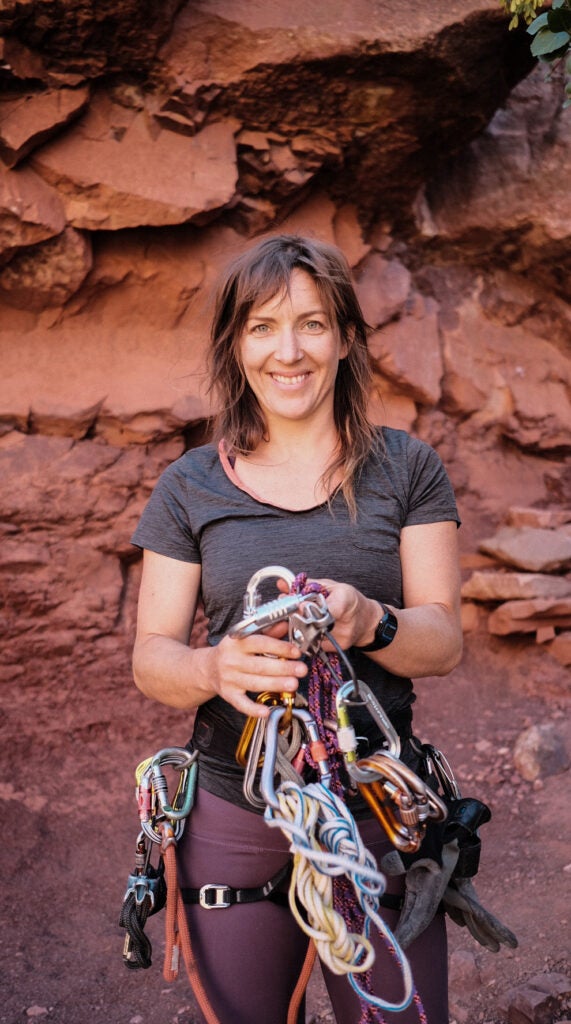 Faith Dickey, a guide in Moab, holds climbing equipment