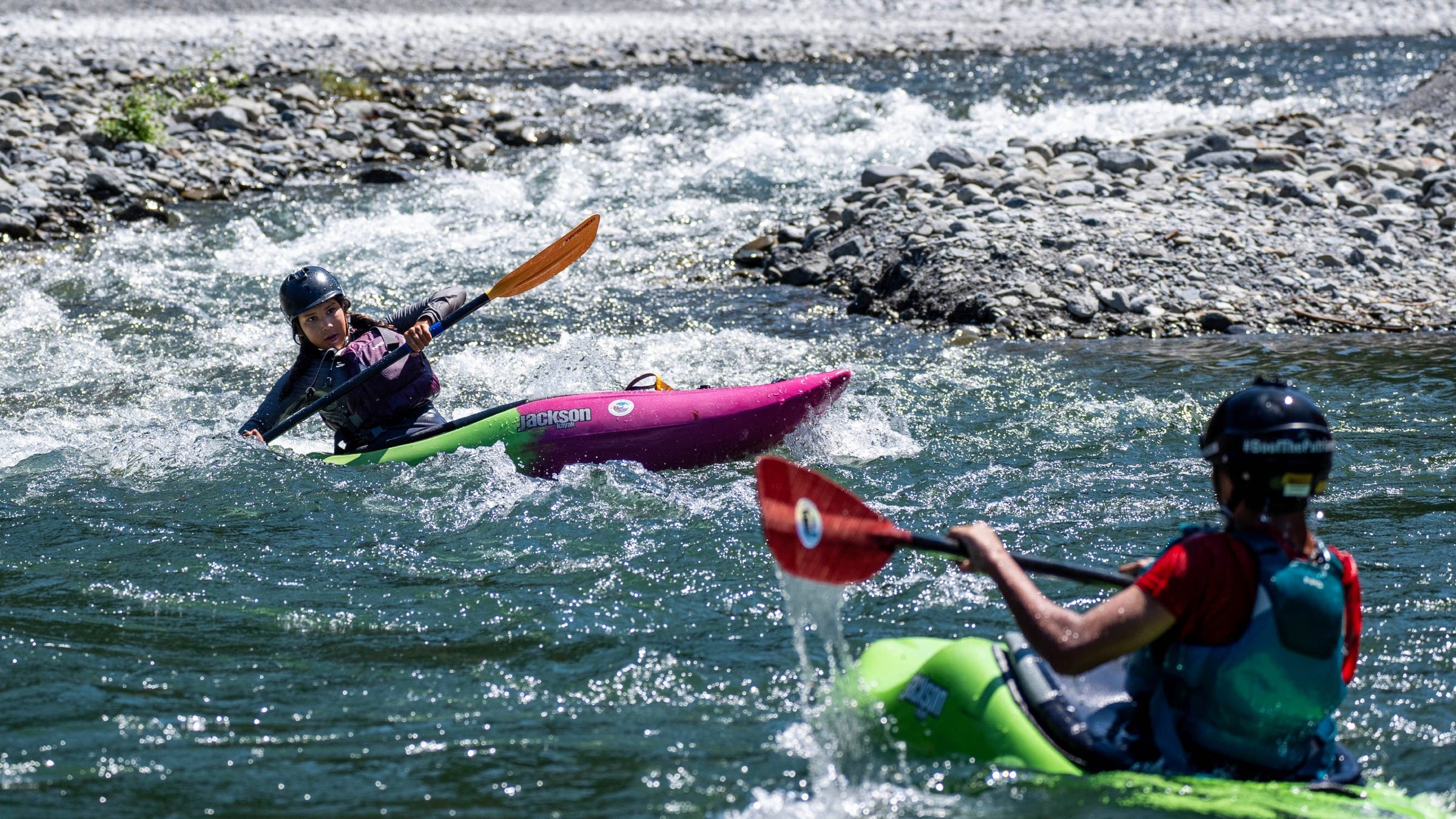 Two kayakers on a river.