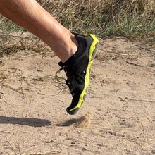 runner's legs in full stride on a trail wearing Vibram FiveFingers