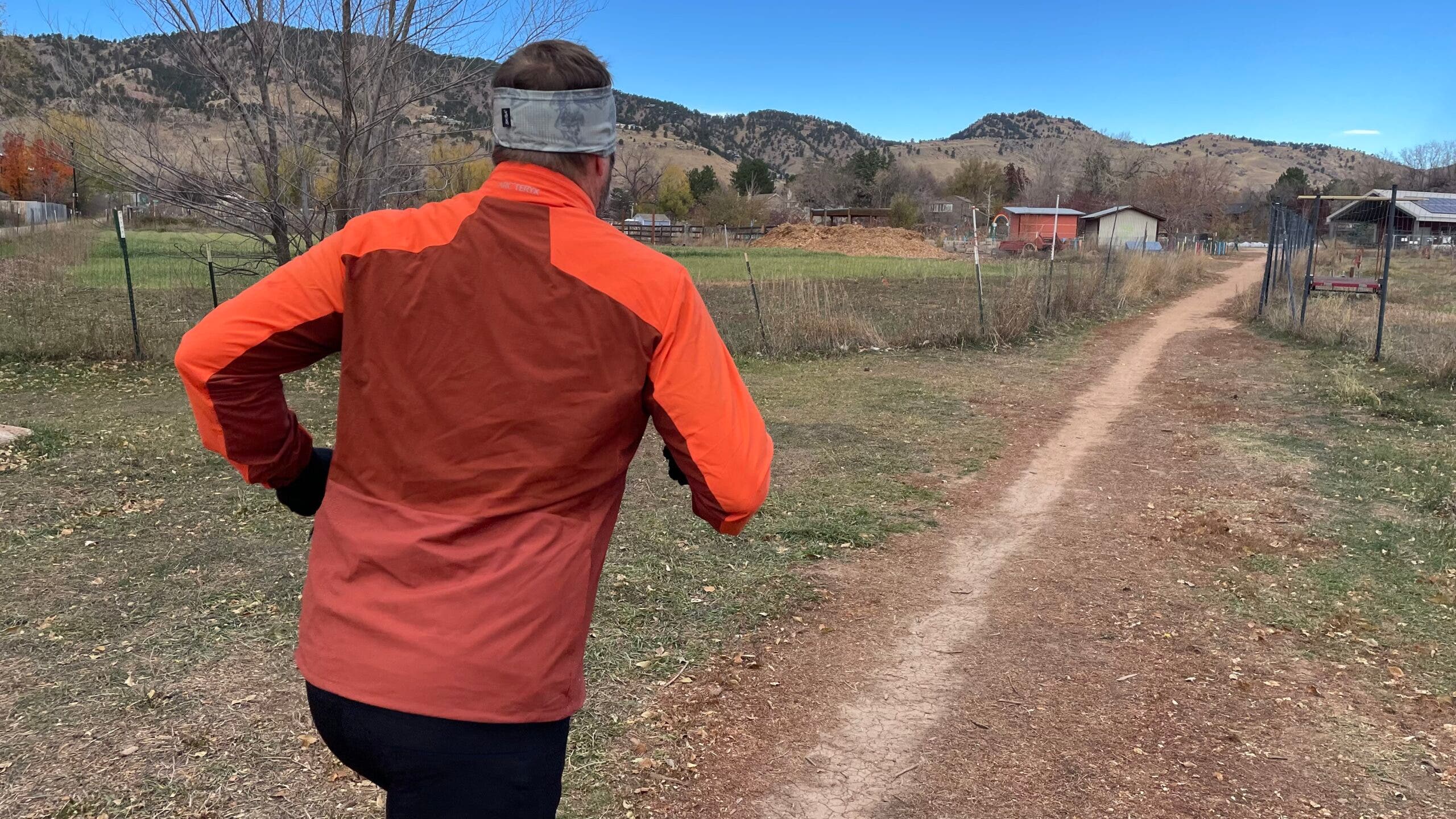 Men's running jacket winter test on trail in mountains