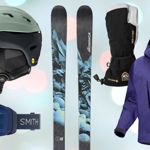 Ski helmet, goggles, skis, gloves, and jacket on twinkle light background