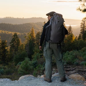 Everything You Need to Get Started Rucking person on overlook with pack on while rucking