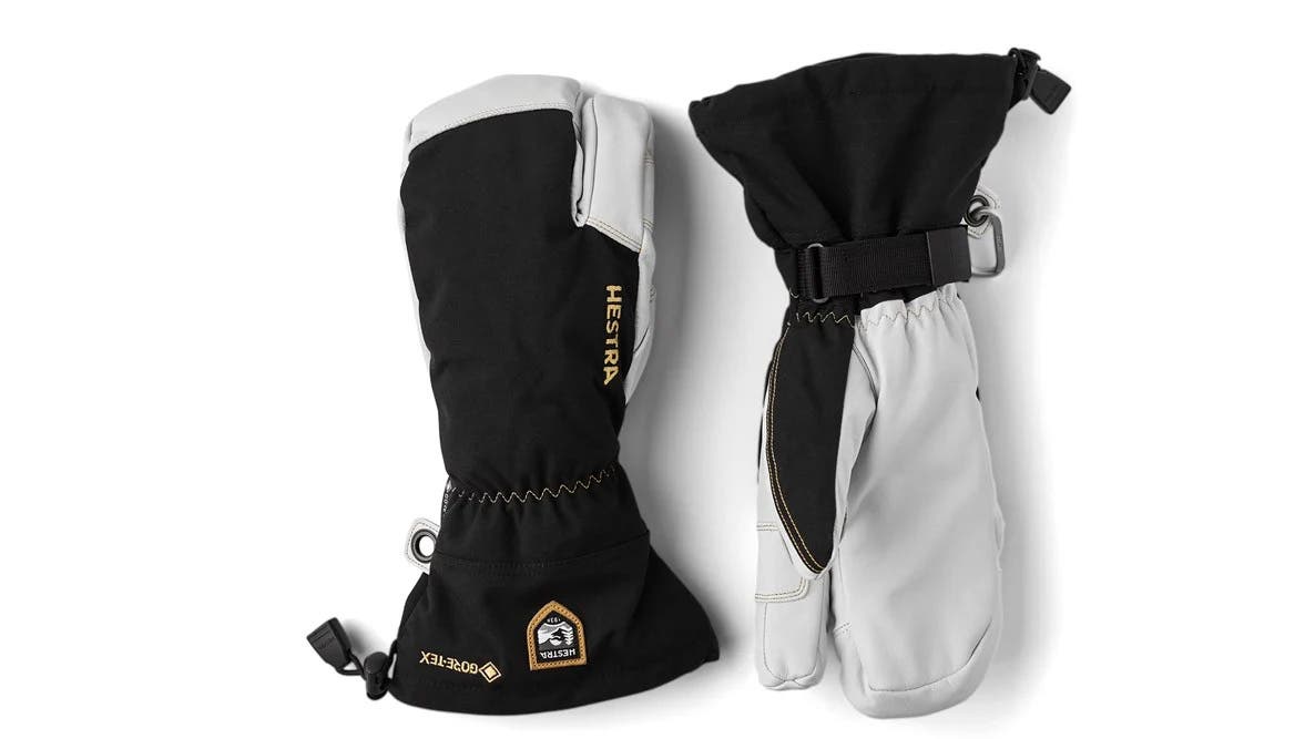 Black and white Hestra Gore-Tex 3-Finger ski gloves on white background
