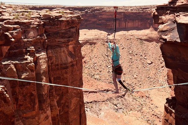 accessible adventure: a woman with a prosthetic leg walks a highline in the desert of moab