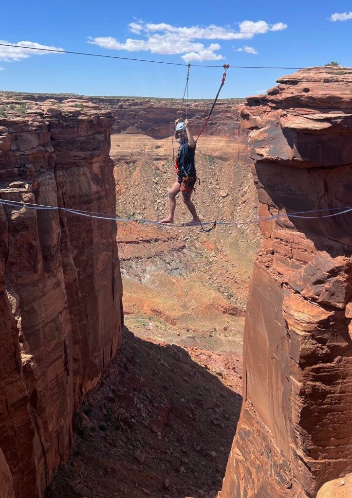a man with a spinal cord injury walking on a highline